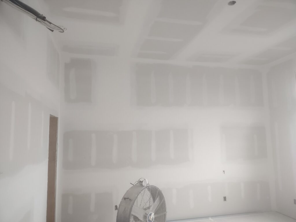 Smooth skim-coated drywall walls ready for painting